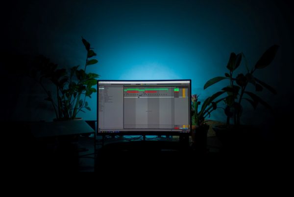 Pc in dark lighting with plants in the background