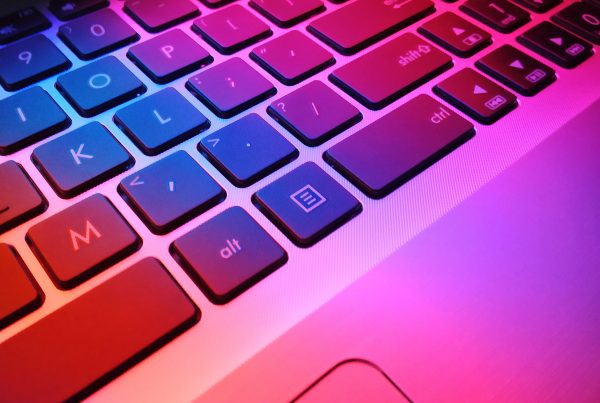 keyboard with red lighting shadowed onto it