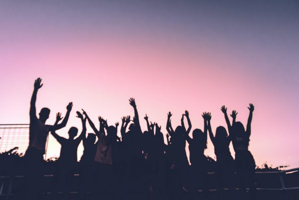 people with their hands in the air having a good time