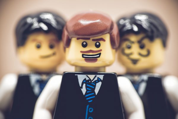 1 lego figure with brown hair and 2 lego figures with black hair
