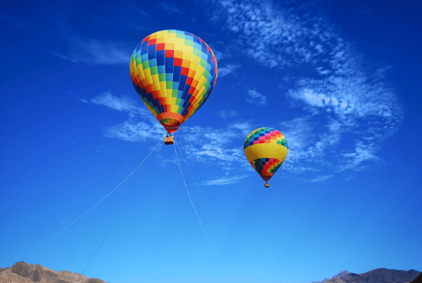 Colourful hot air balloon flying in a blue sky