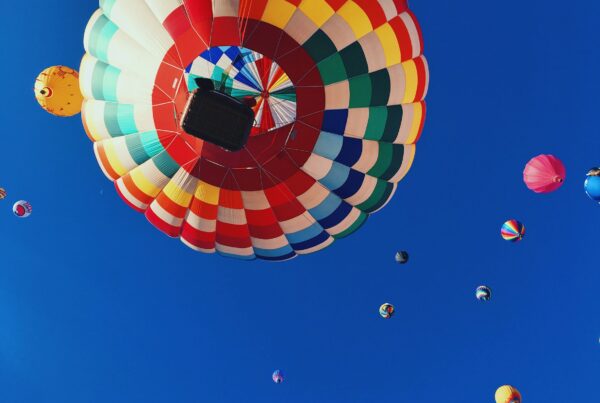 Colourful hot air baloons against a bright blue sky